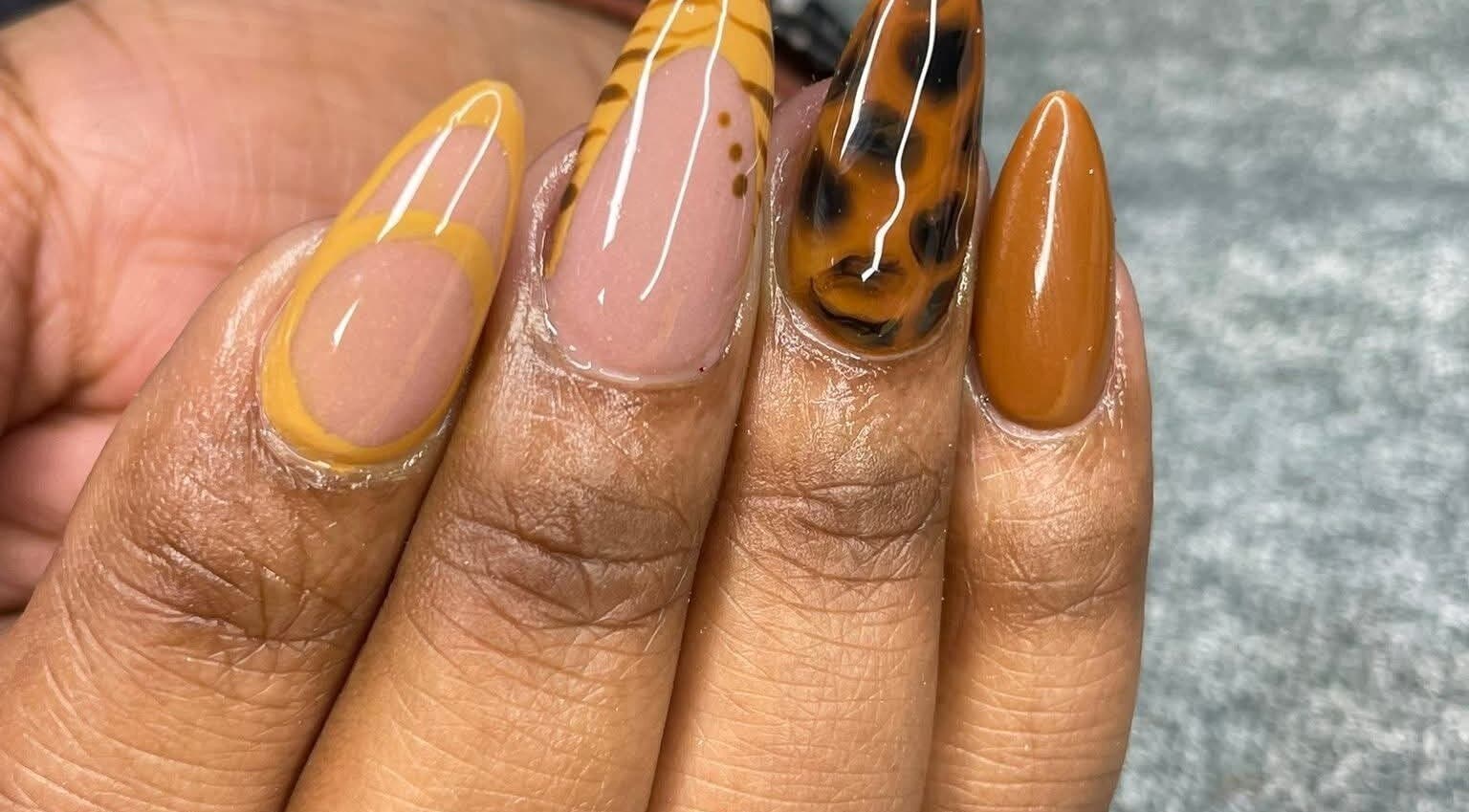 Stylish nail art with tiger and amber design at Hair, Nails and Beauty Studio, Centurion, Gauteng, ZA.