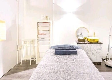 Relaxing treatment room at The Spa Room, Singapore, SG, featuring cozy bed and ambient lighting.