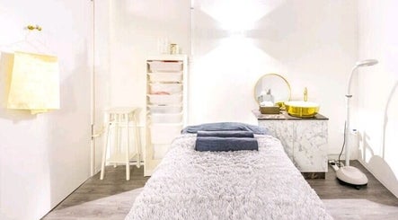 Relaxing treatment room at The Spa Room, Singapore, SG, featuring cozy bed and ambient lighting.
