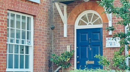 Entrance of L.A Beauty at Victoria Alice Brows Studio, Newbury, England with blue door and brick facade.