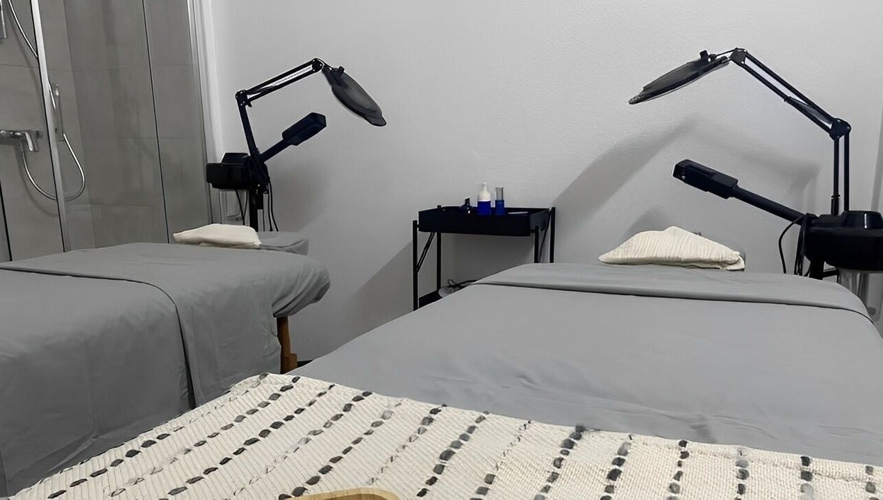 Treatment room at MP Spa and Aesthetics Clinic in Oistins, Christ Church, featuring two spa beds and equipment.