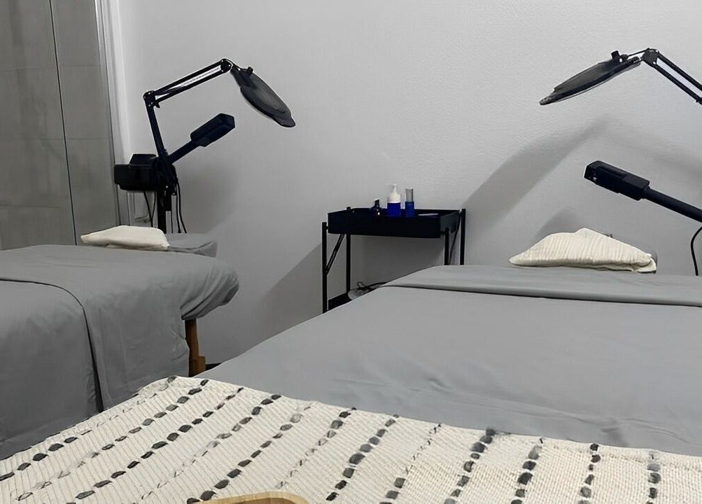 Treatment room at MP Spa and Aesthetics Clinic in Oistins, Christ Church, featuring two spa beds and equipment.