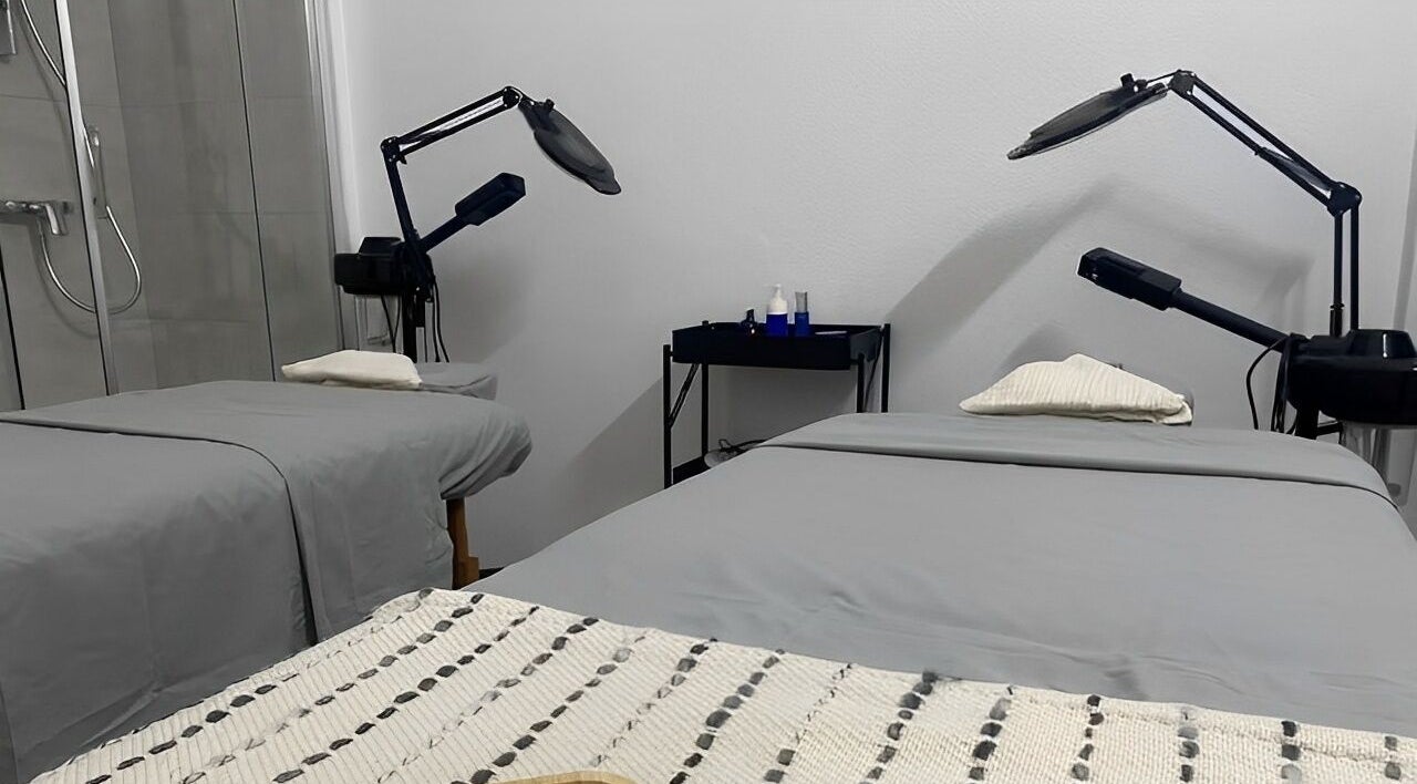 Treatment room at MP Spa and Aesthetics Clinic in Oistins, Christ Church, featuring two spa beds and equipment.