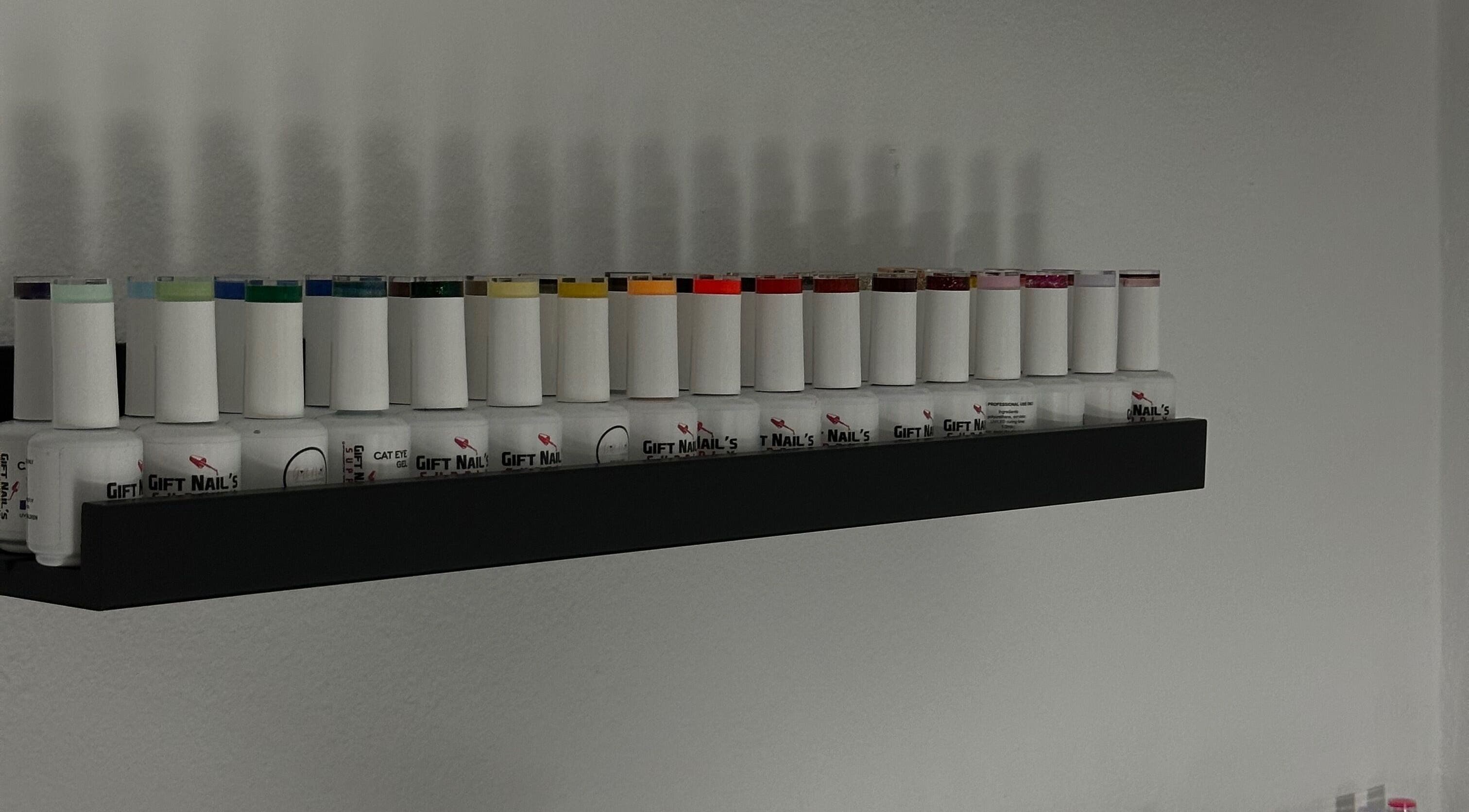 Variety of nail polish bottles on a shelf at Leslie Nails PR, Aguas Buenas, Aguas Buenas, PR.