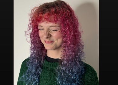 Stylist at Scrambled Meggs Hair @ 87 Collective showcases vibrant curls, Edinburgh, Scotland, GB.