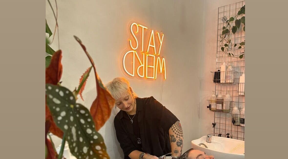 Colorful interior at Scrambled Meggs Hair at Saoirse Studio, Edinburgh, Scotland, GB, featuring neon sign and stylist.