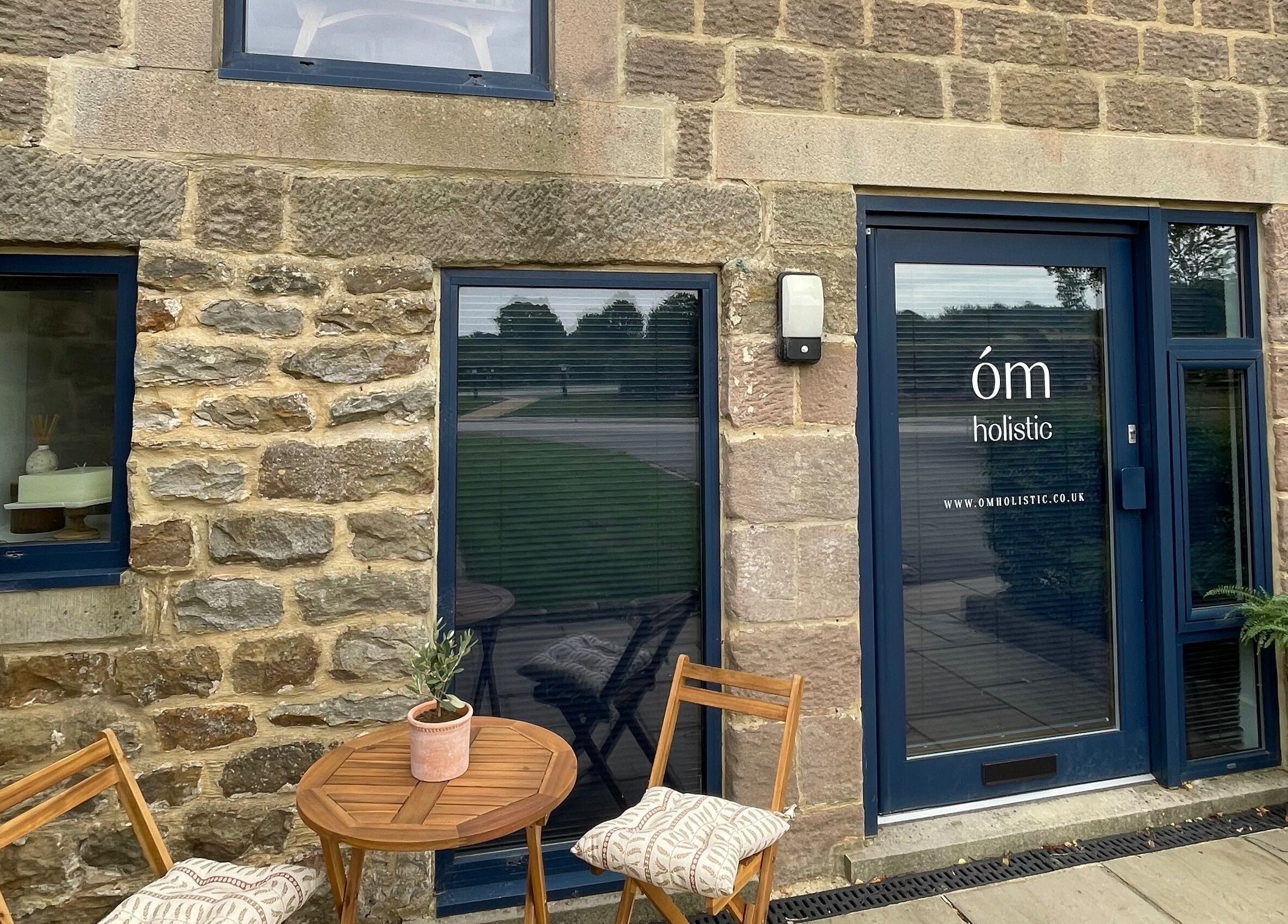 Front entrance of The Bothy – A Sanctuary By ōm Holistic in Harrogate, England, GB, showcasing rustic stone design.