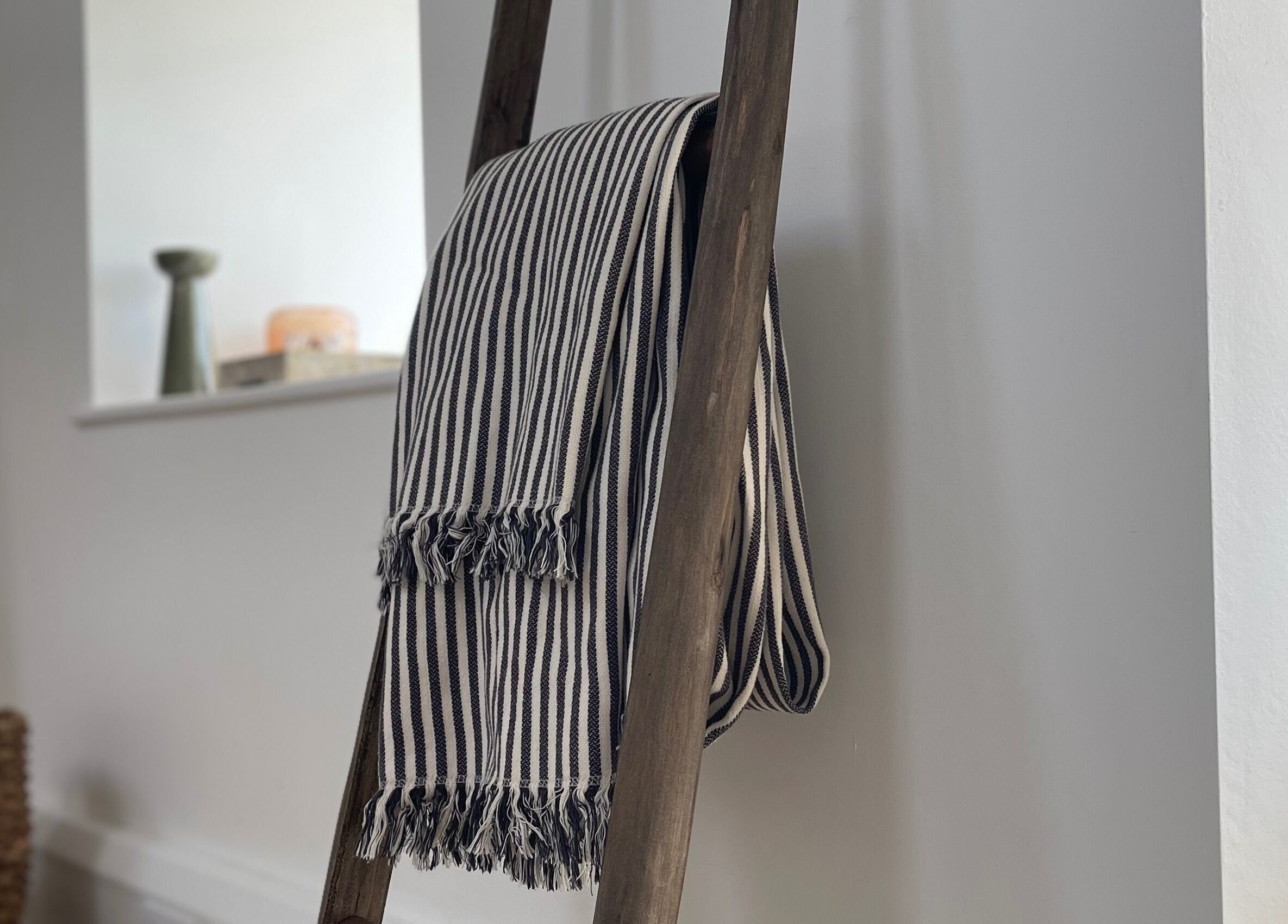 A striped blanket drapes over a wooden ladder at The Bothy – A Sanctuary By ōm Holistic, Harrogate, England, GB.