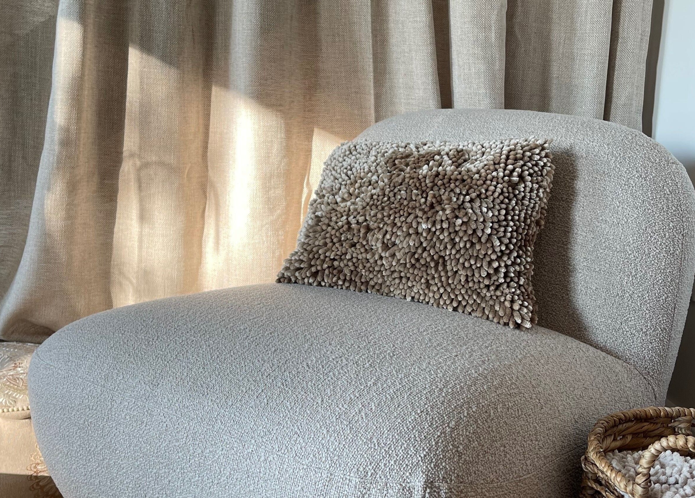 Comfortable chair with textured pillow at The Bothy – A Sanctuary By ōm Holistic, Harrogate, England, GB.