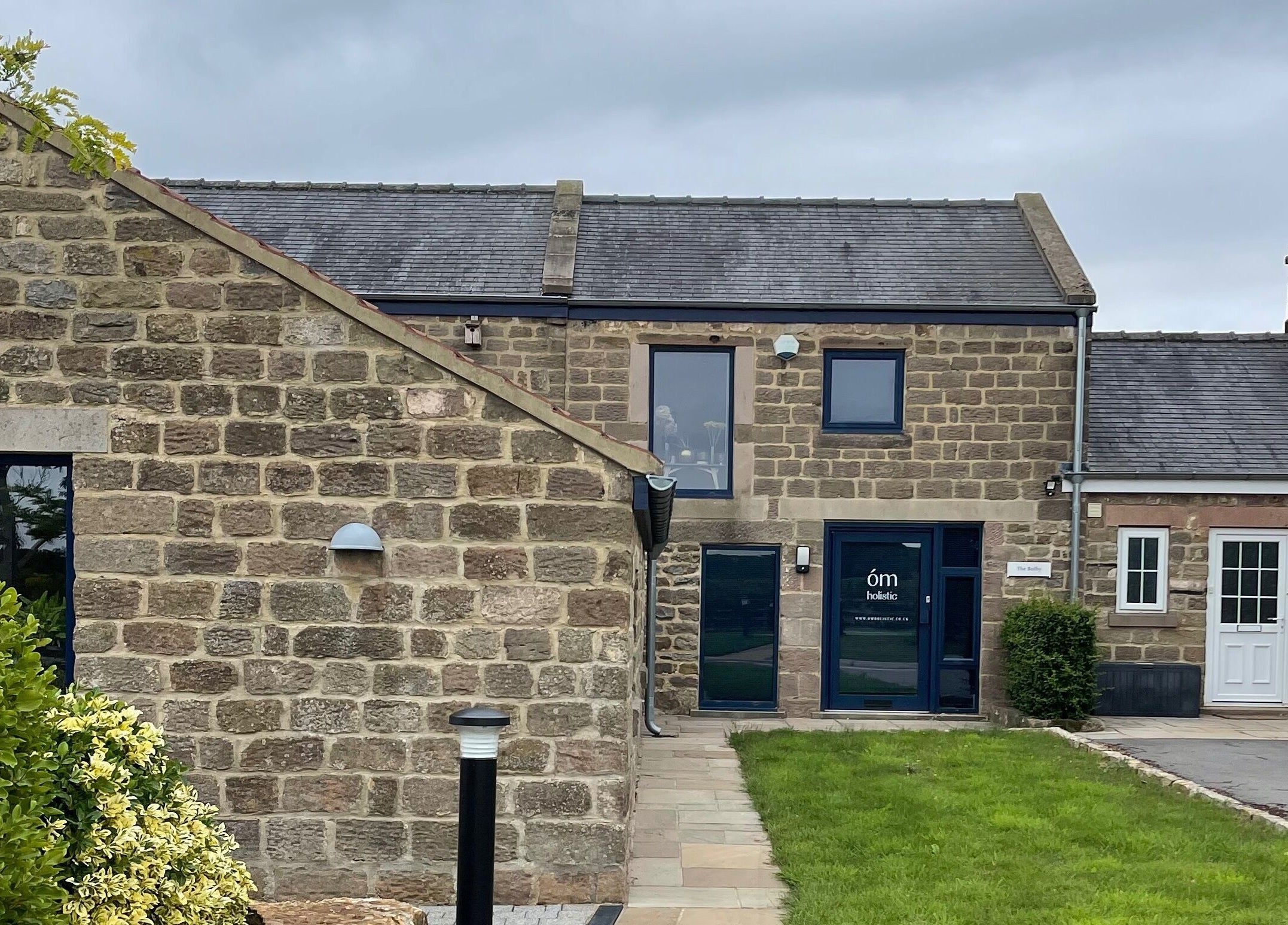 The Bothy – A Sanctuary By ōm Holistic in Harrogate, England, features a peaceful stone exterior.