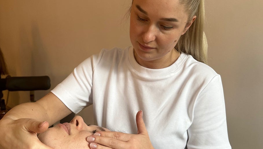 Therapist performing facial massage at KC Beauty Room in Peterborough, England, GB.