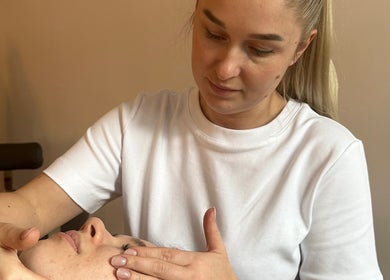 Therapist performing facial massage at KC Beauty Room in Peterborough, England, GB.