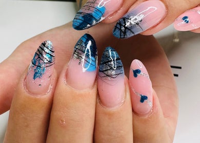 Intricate nail art design at KC Beauty Room, Peterborough, England, GB showcasing blue and silver patterns.