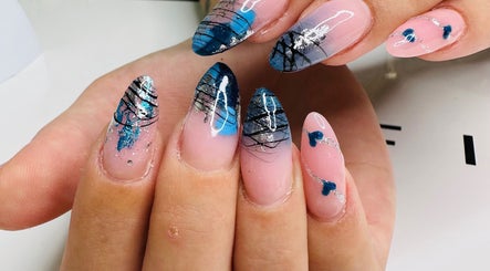 Intricate nail art design at KC Beauty Room, Peterborough, England, GB showcasing blue and silver patterns.