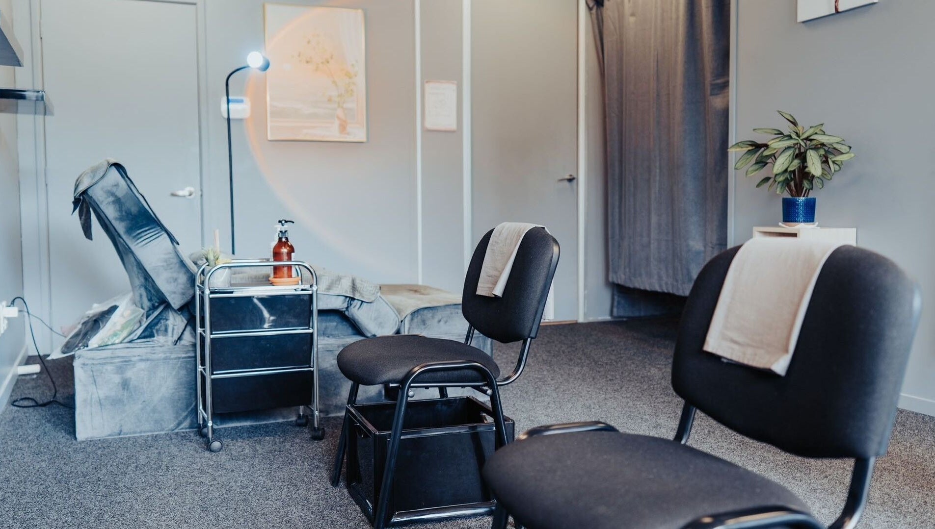 Inviting massage room at JM's Massage in Auckland, Auckland, NZ, featuring cozy seating and calm decor.