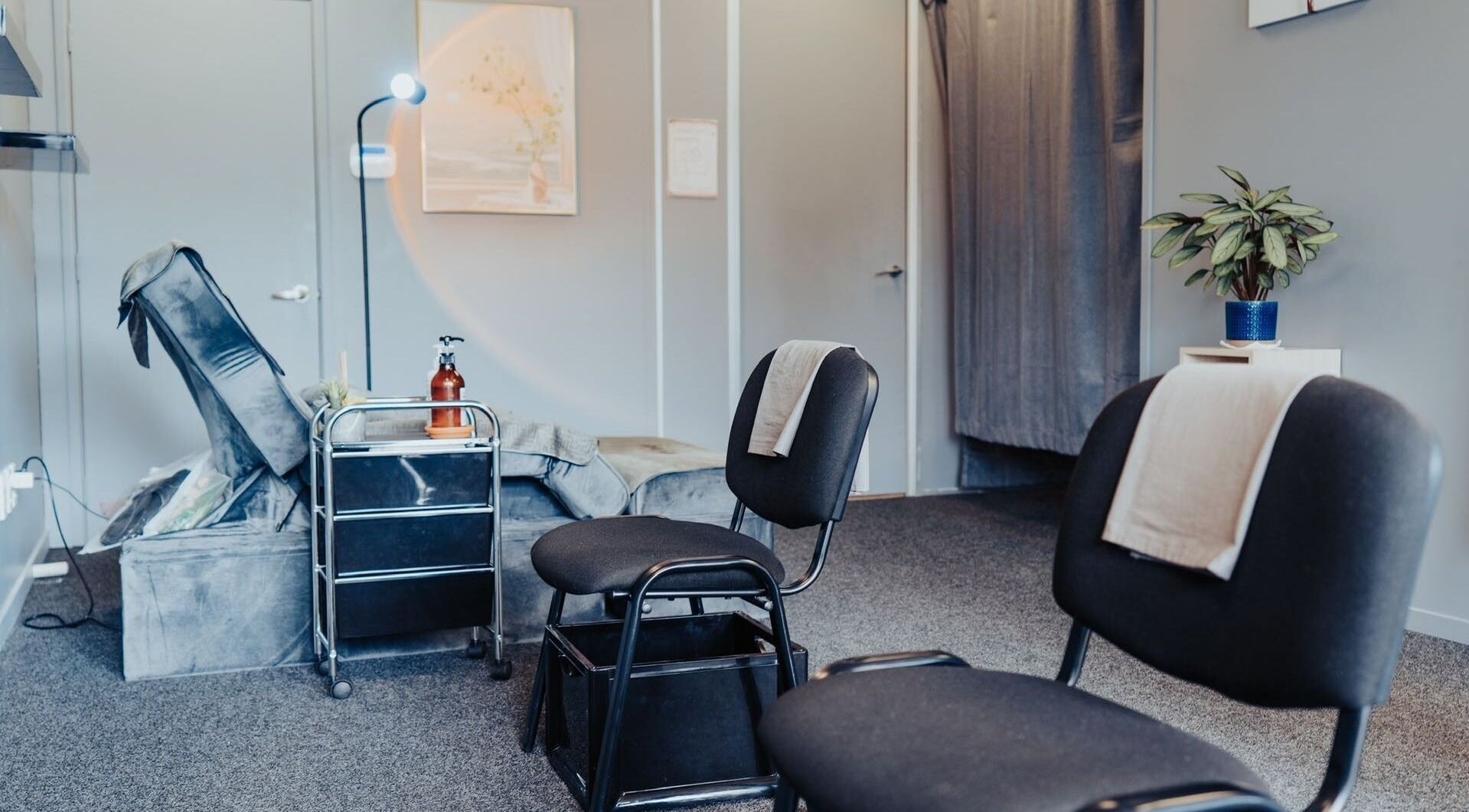 Inviting massage room at JM's Massage in Auckland, Auckland, NZ, featuring cozy seating and calm decor.