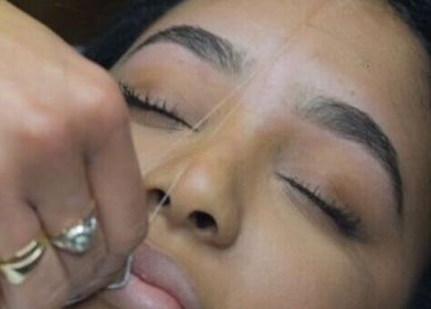 A client enjoys precise eyebrow threading at The Creative Beauty Studio, Harlow, England, GB.