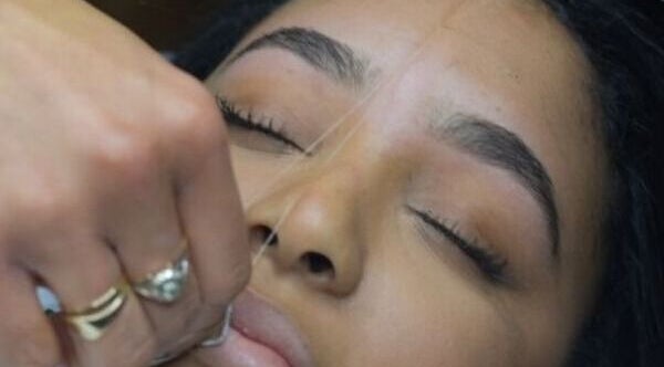 A client enjoys precise eyebrow threading at The Creative Beauty Studio, Harlow, England, GB.