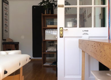 Relaxed interior of Mulberry Tree Cottage Lyno Studio in Cape Town, Western Cape, ZA with a massage table.
