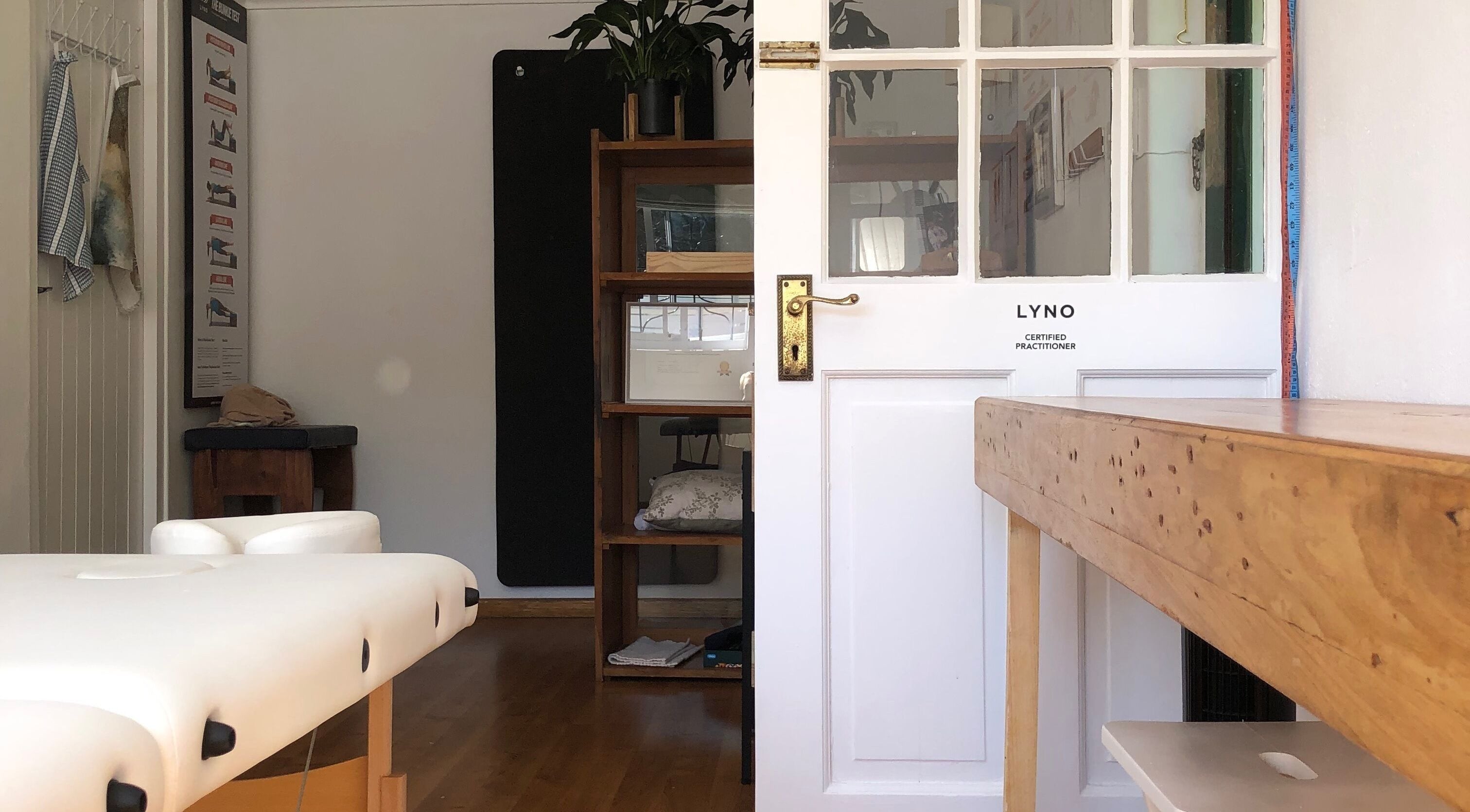 Relaxed interior of Mulberry Tree Cottage Lyno Studio in Cape Town, Western Cape, ZA with a massage table.