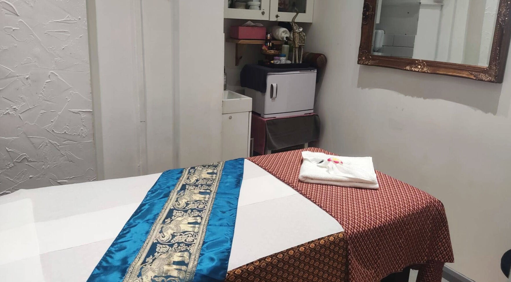 Tranquil therapy room at Pim Thai Therapy London, England, GB, featuring a massage table with elegant decor.