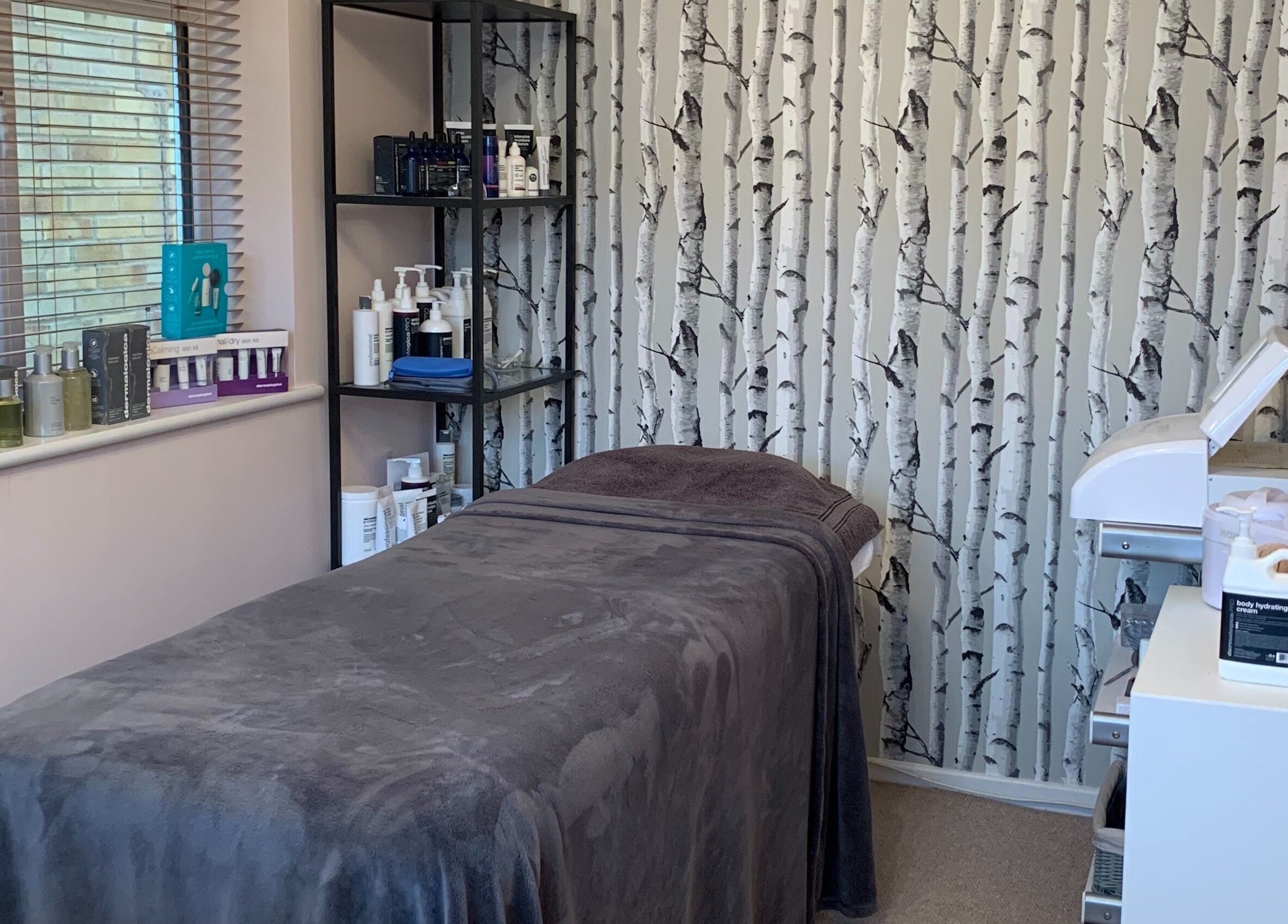 Tranquil treatment room at Perfect Touch in Wallingford, England, GB, featuring a massage table and skincare products.