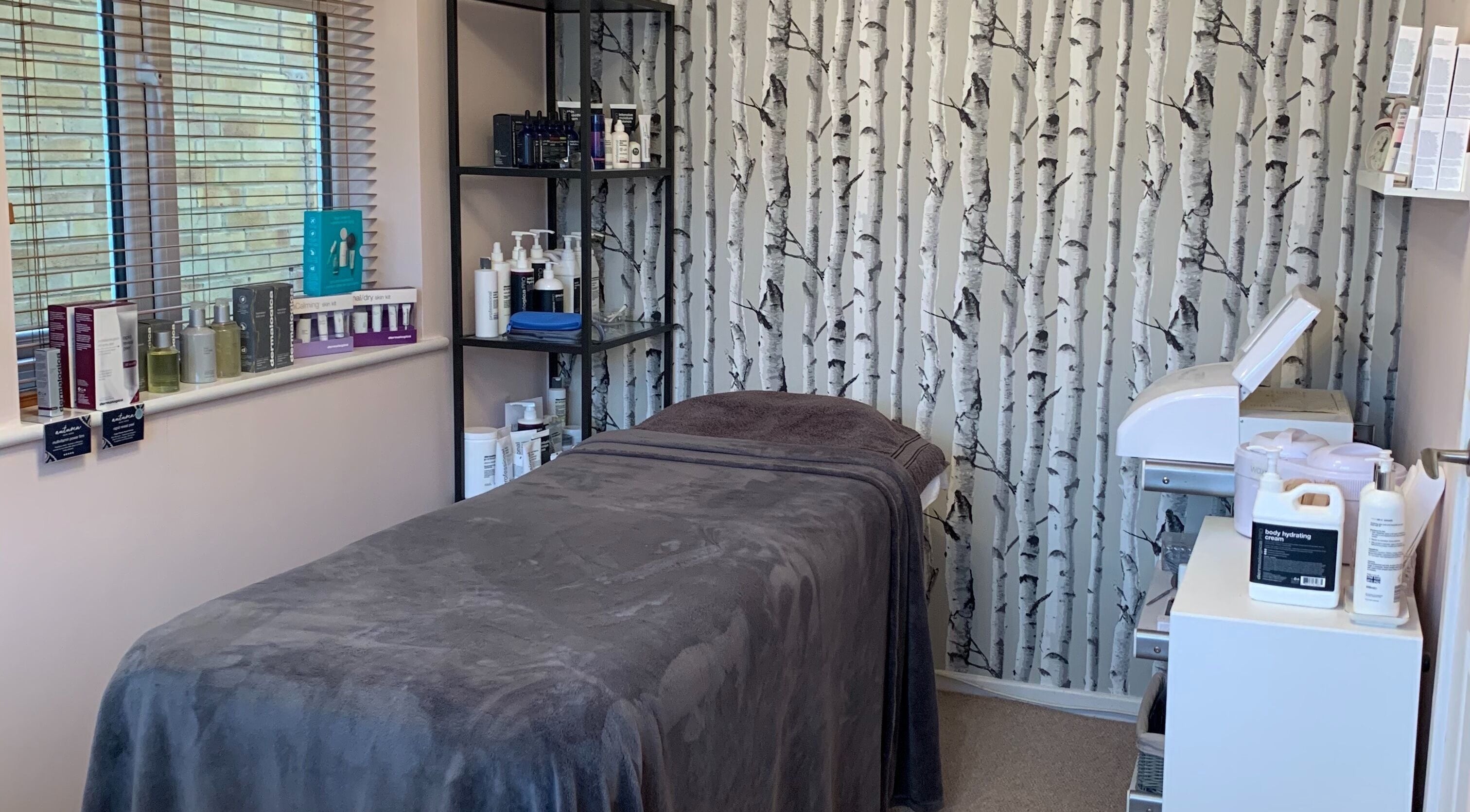 Tranquil treatment room at Perfect Touch in Wallingford, England, GB, featuring a massage table and skincare products.