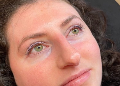 Close-up of a satisfied client at Lara Beauty Collective, Randwick, New South Wales, AU with natural makeup.