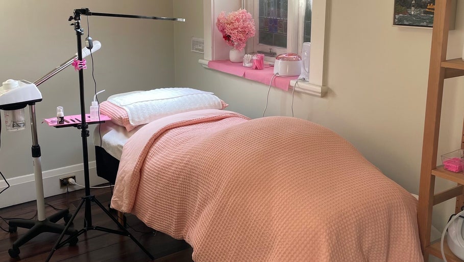 Relaxing treatment room at Lara Beauty Collective in Randwick, New South Wales, AU with pink decor.