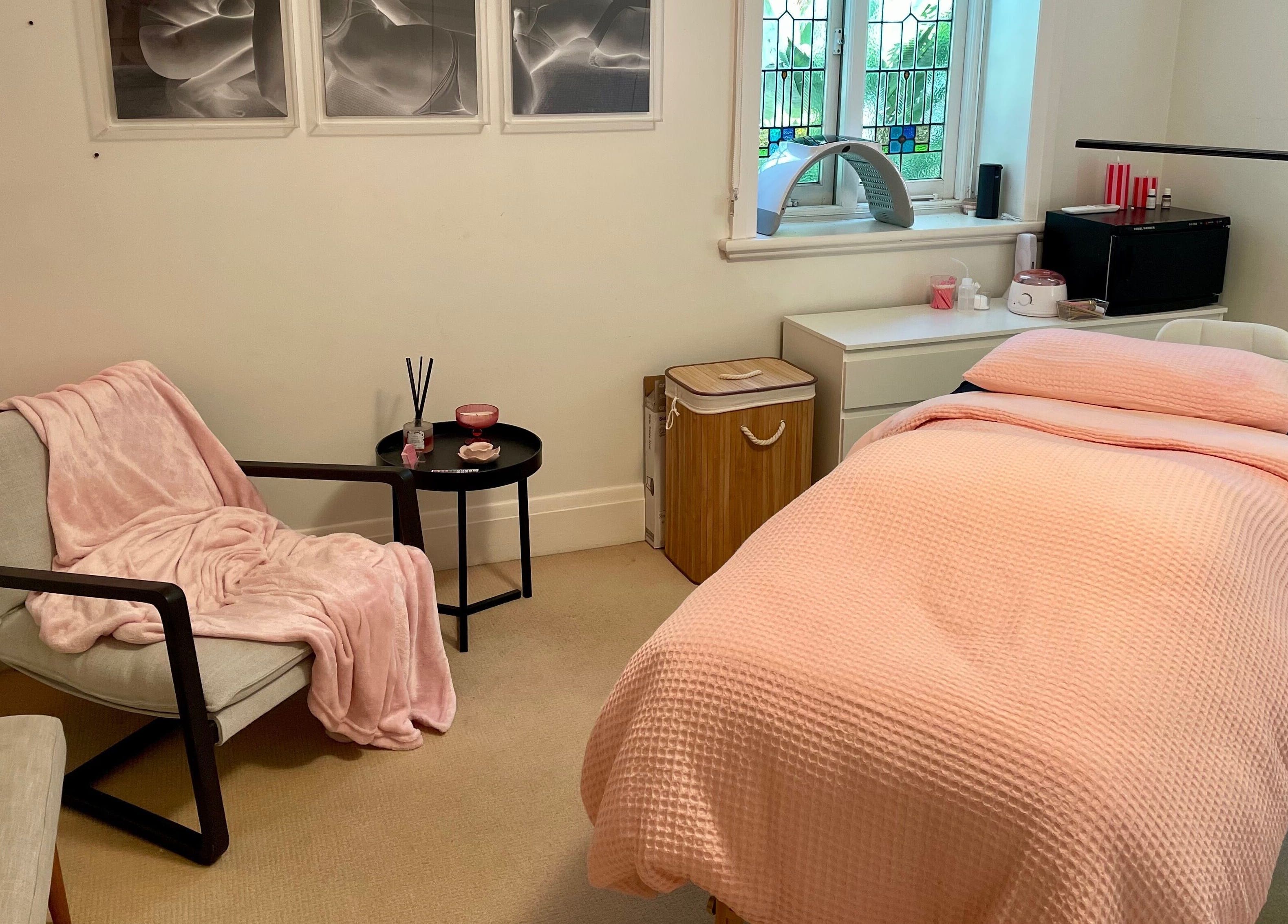 Relaxing treatment room at Lara Beauty Collective in Randwick, New South Wales, AU with plush pink décor.