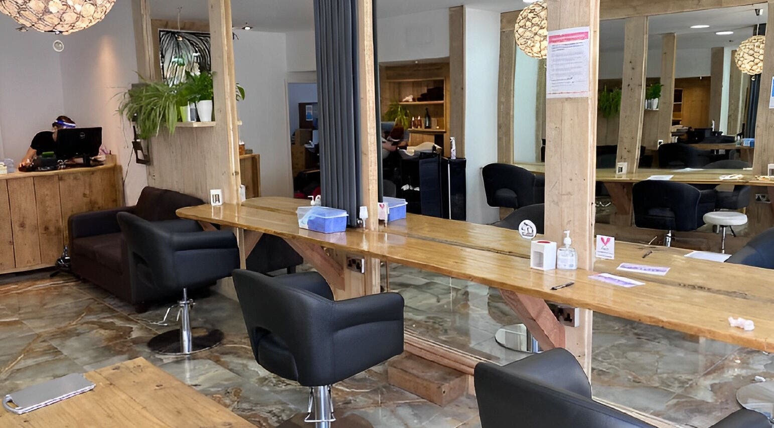 Modern salon interior of Millers Hair and Beauty Ltd in Bristol, England. Cozy chairs and stylish decor.