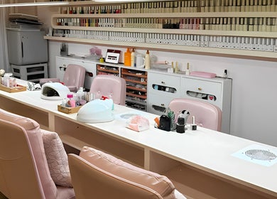 JU Spa nail studio with pink chairs and nail polish racks in Thành Phố Hồ Chí Minh, VN.