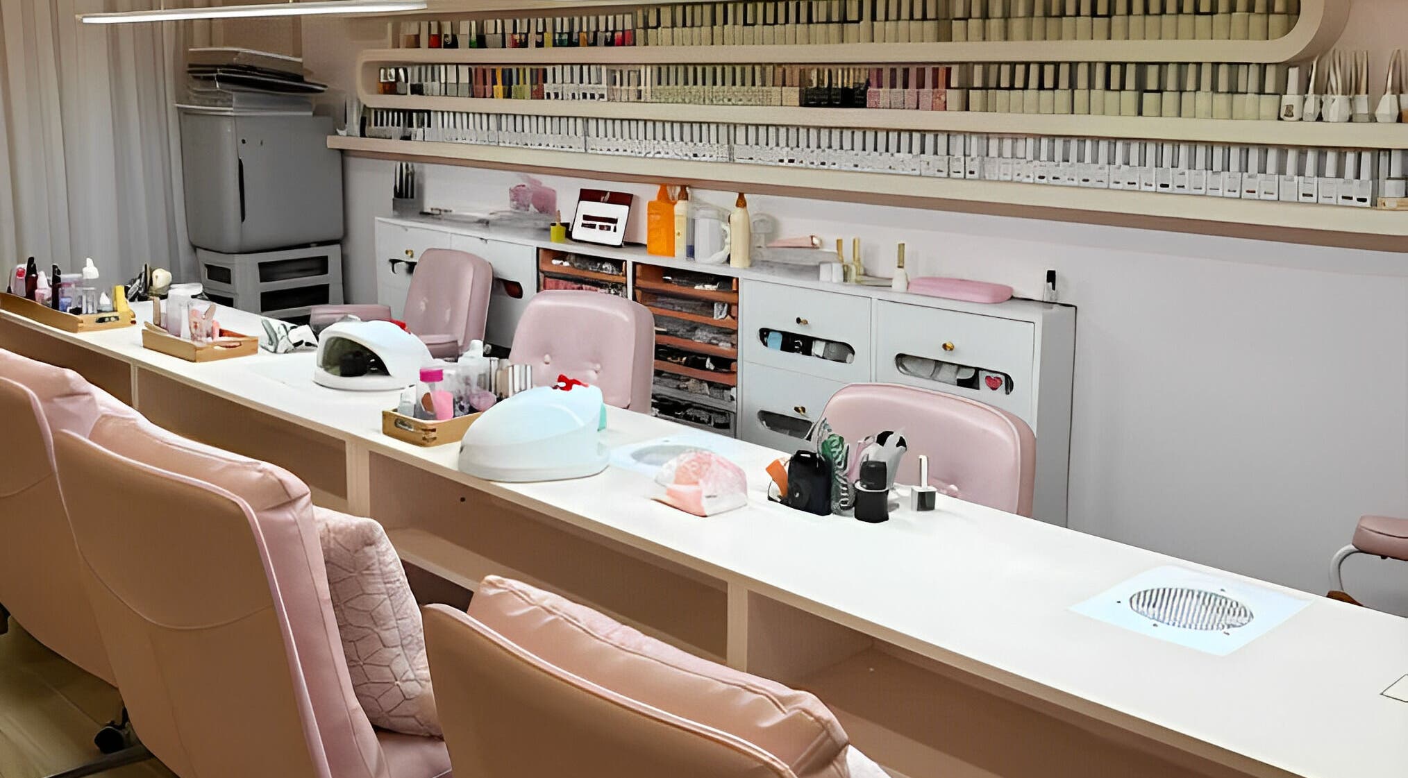 JU Spa nail studio with pink chairs and nail polish racks in Thành Phố Hồ Chí Minh, VN.