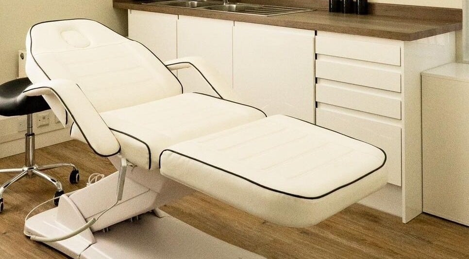 Modern treatment room at Natalie Aesthetics, Great Shelford, England, GB, featuring a sleek white treatment chair.