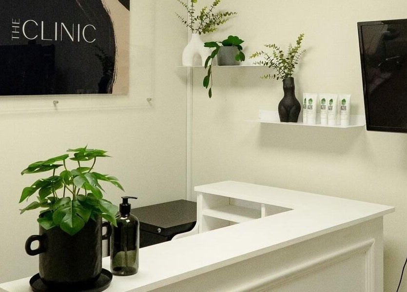 Reception area at Natalie Aesthetics, Great Shelford, England. Features modern decor and welcome desk.