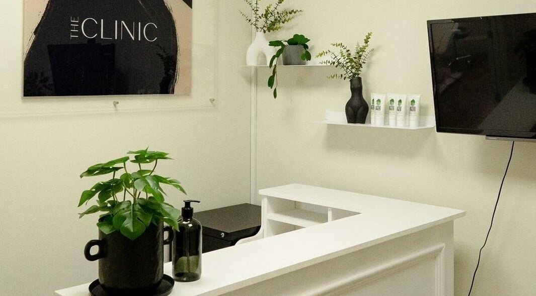 Reception area at Natalie Aesthetics, Great Shelford, England. Features modern decor and welcome desk.