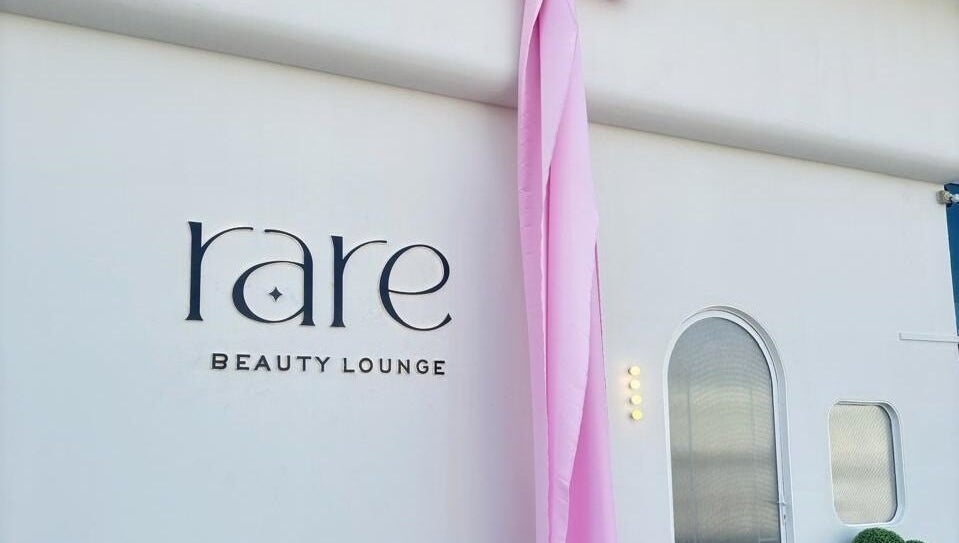 Rare Beauty Saloon's elegant facade with pink decor in Ajman, AE, showcasing its modern exterior.