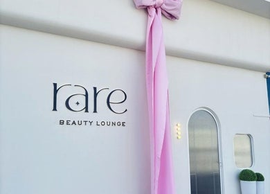 Rare Beauty Saloon's elegant facade with pink decor in Ajman, AE, showcasing its modern exterior.