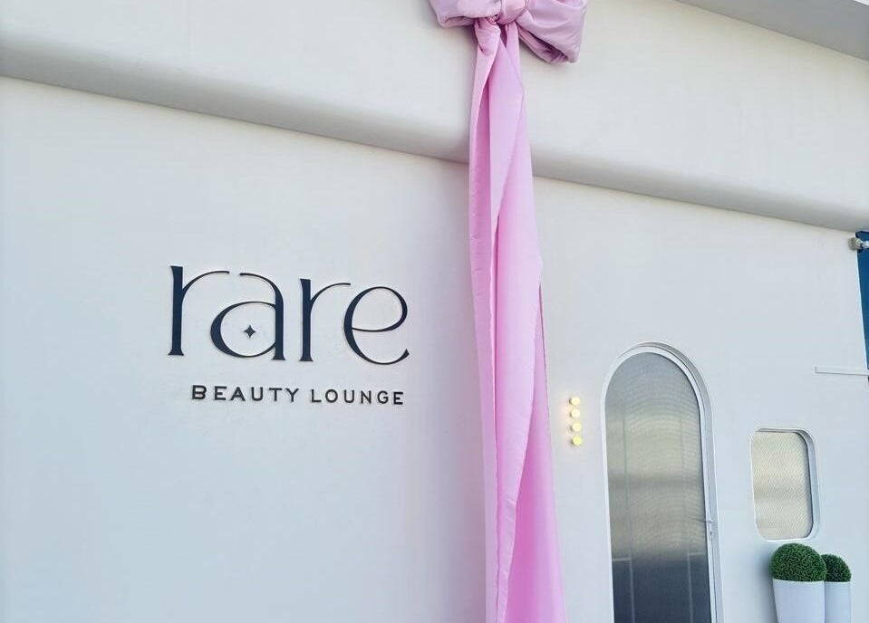 Rare Beauty Saloon's elegant facade with pink decor in Ajman, AE, showcasing its modern exterior.