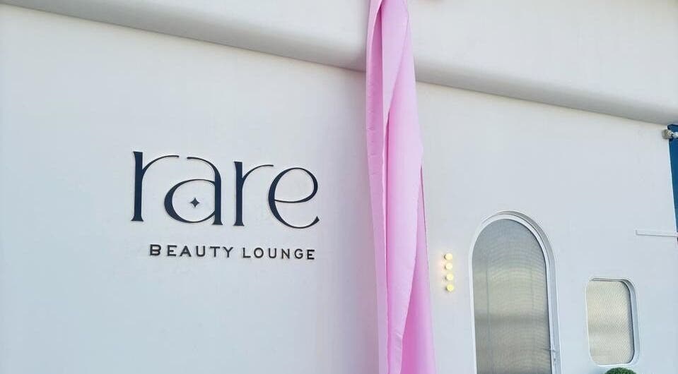Rare Beauty Saloon's elegant facade with pink decor in Ajman, AE, showcasing its modern exterior.