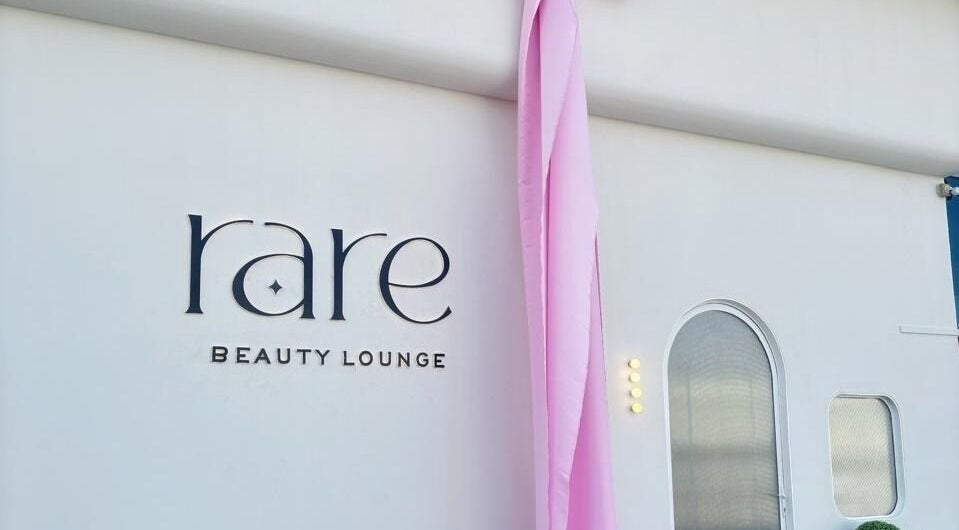 Rare Beauty Saloon's elegant facade with pink decor in Ajman, AE, showcasing its modern exterior.