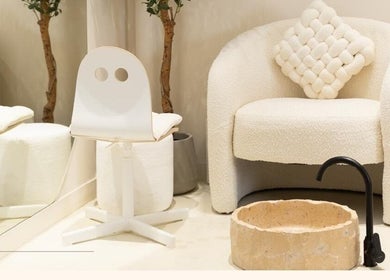 Elegant waiting area at Rare Beauty Saloon, Ajman, AE featuring cozy chairs and modern decor.