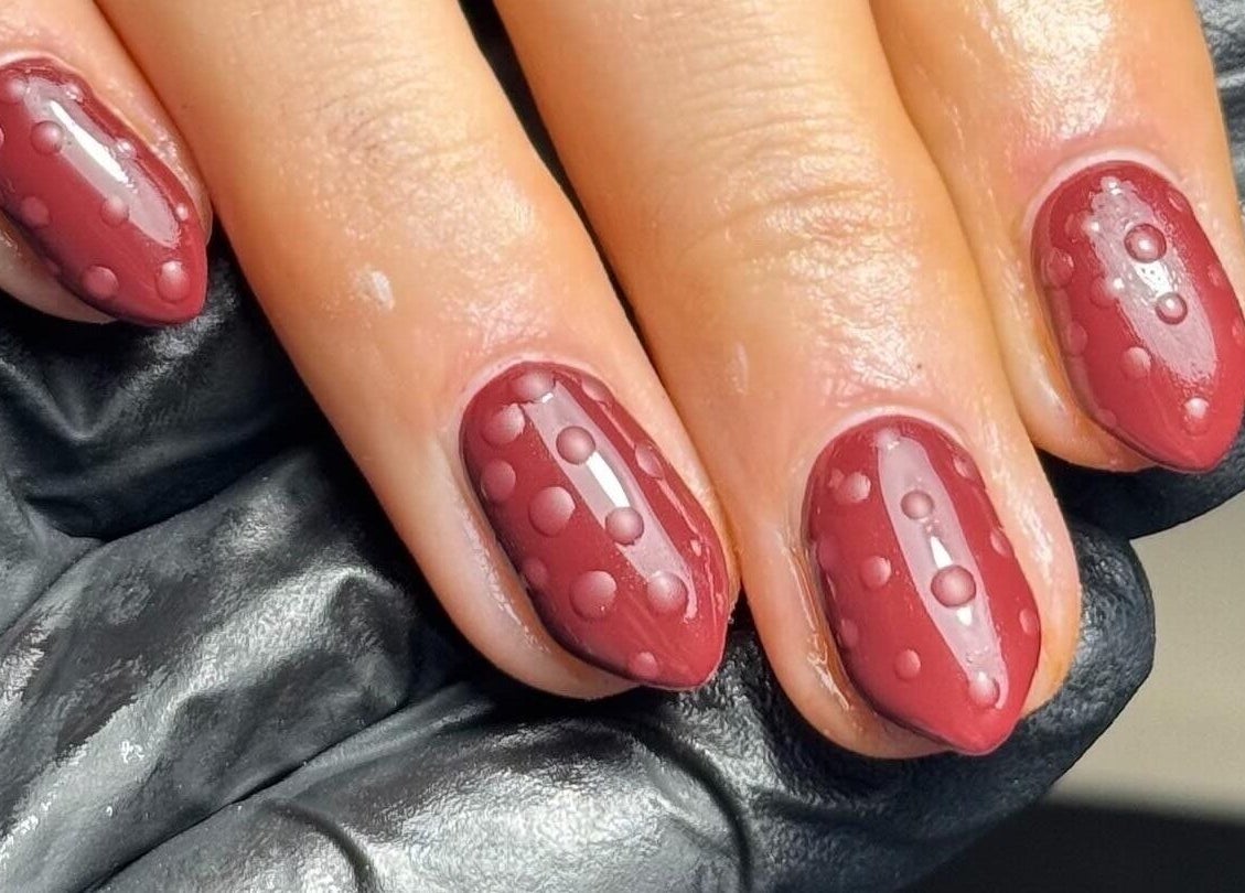 Elegant dotted nail art in deep red at Beauty Bliss By Becca, Annan, Scotland, GB.