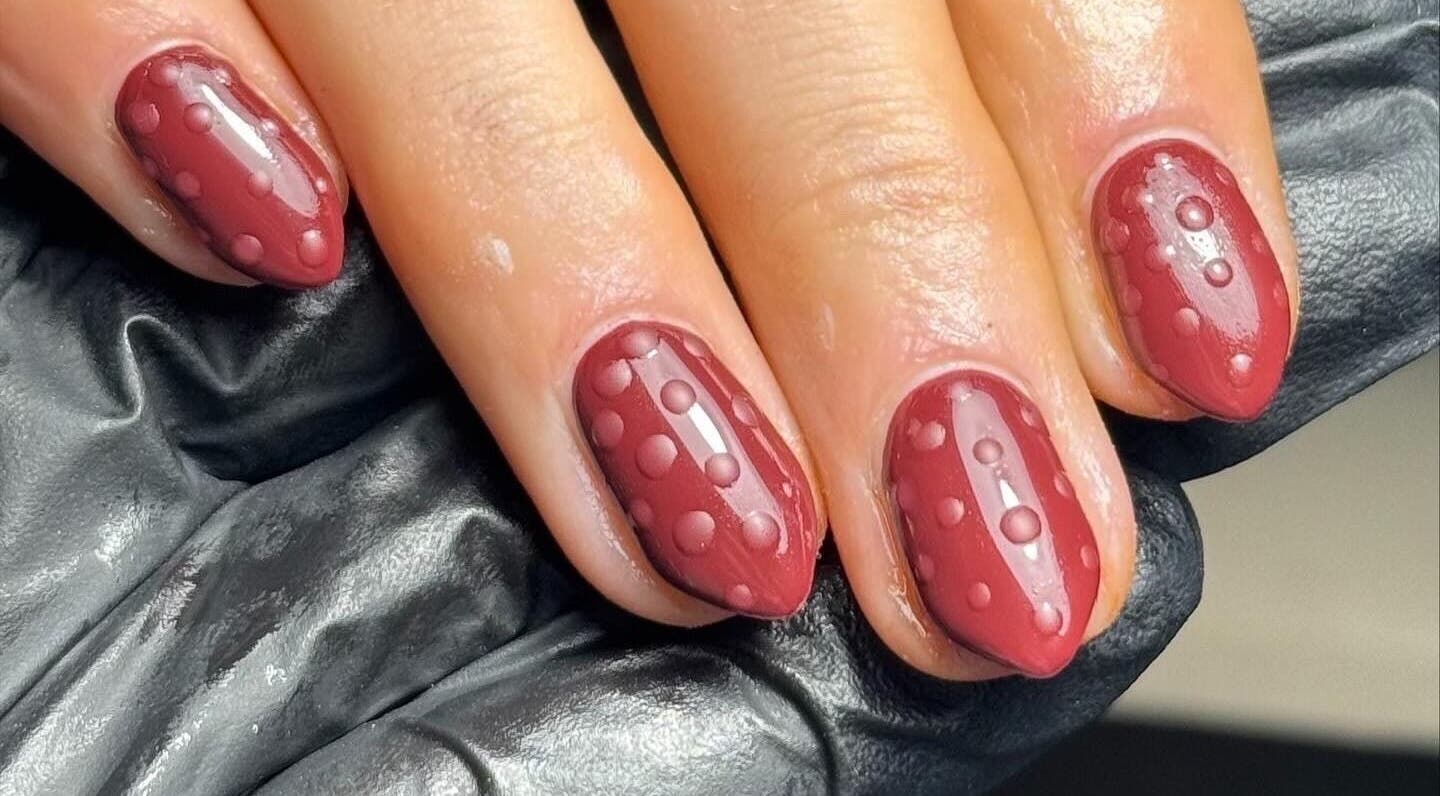 Elegant dotted nail art in deep red at Beauty Bliss By Becca, Annan, Scotland, GB.