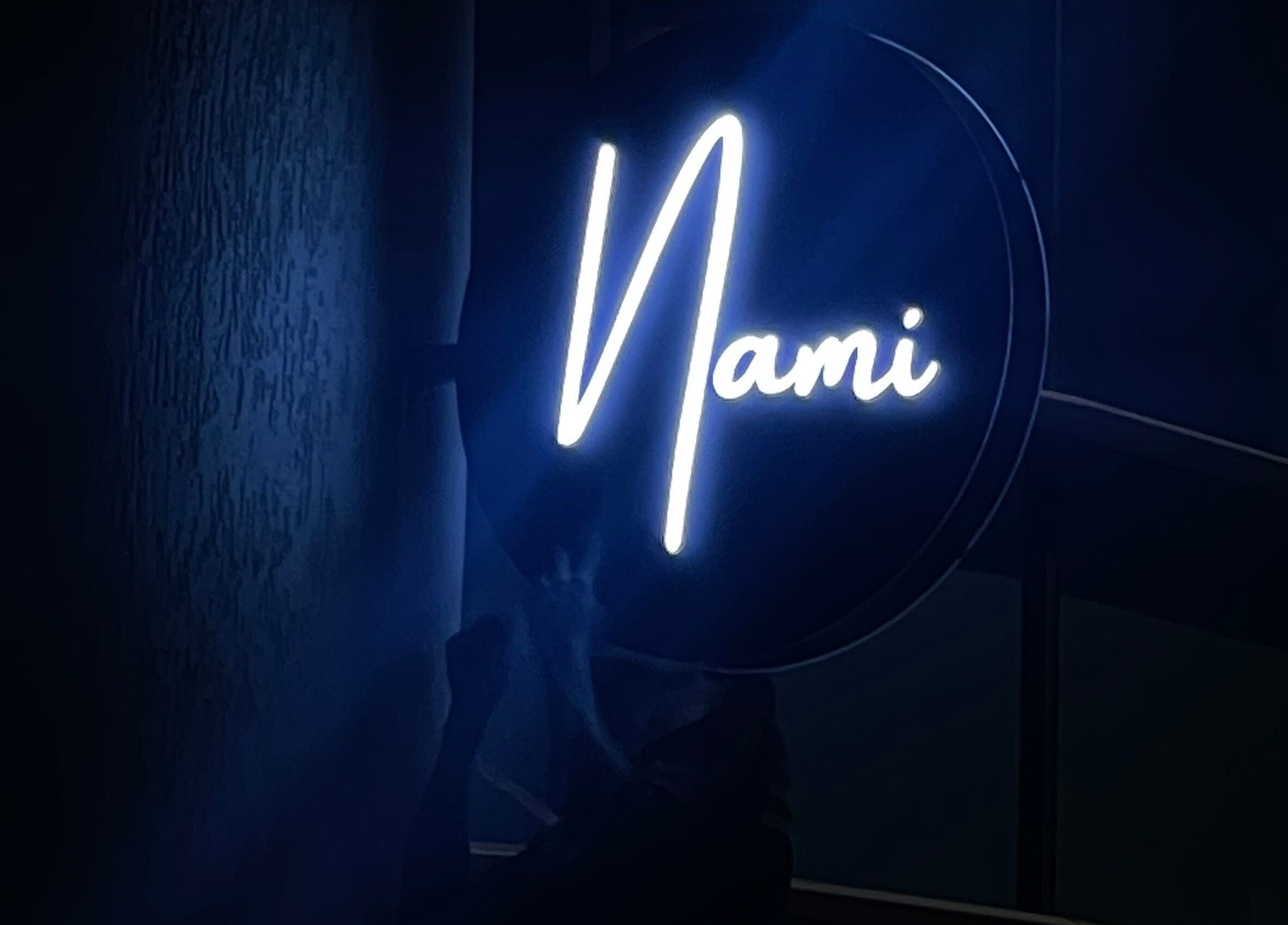 Illuminated Nami Lagos sign at night, located in Lagos, Lagos, NG. Modern elegance meets urban style.