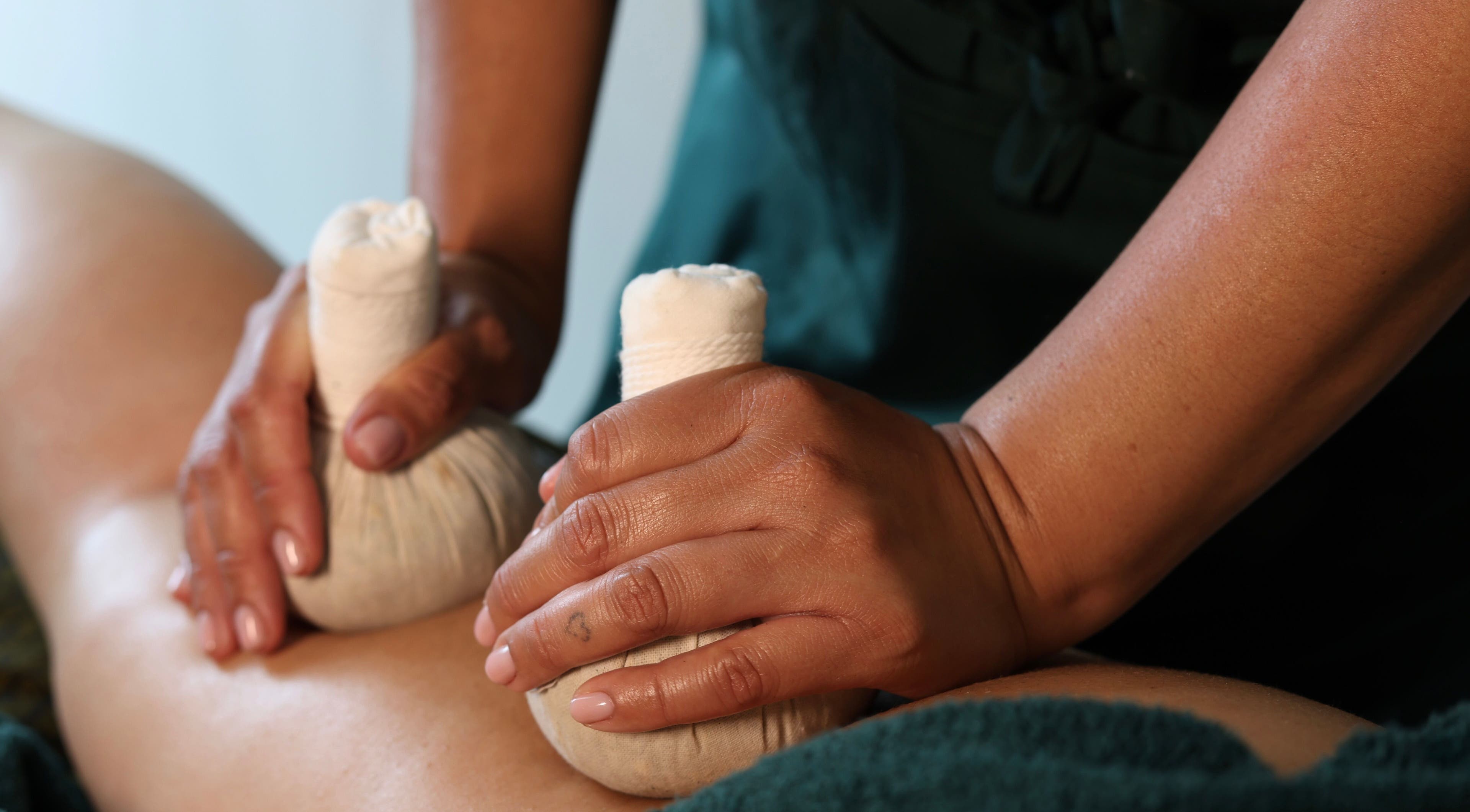 Herbal compress massage at Armonia (London Bridge Clinic), London, England, GB, promoting relaxation and wellness.