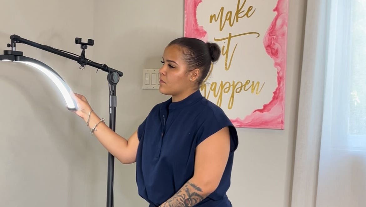 Technician adjusts light at AP Beauty, Kingston, St. Andrew Parish, JM for beauty treatment session.