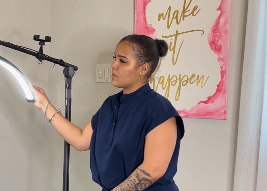 Technician adjusts light at AP Beauty, Kingston, St. Andrew Parish, JM for beauty treatment session.