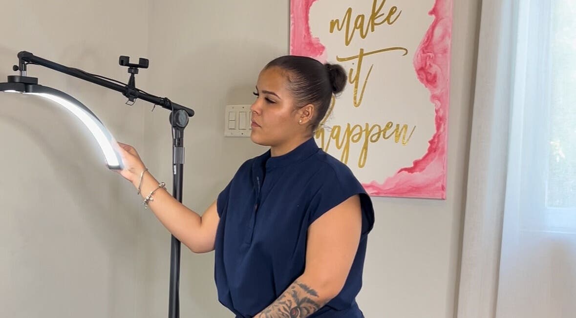 Technician adjusts light at AP Beauty, Kingston, St. Andrew Parish, JM for beauty treatment session.