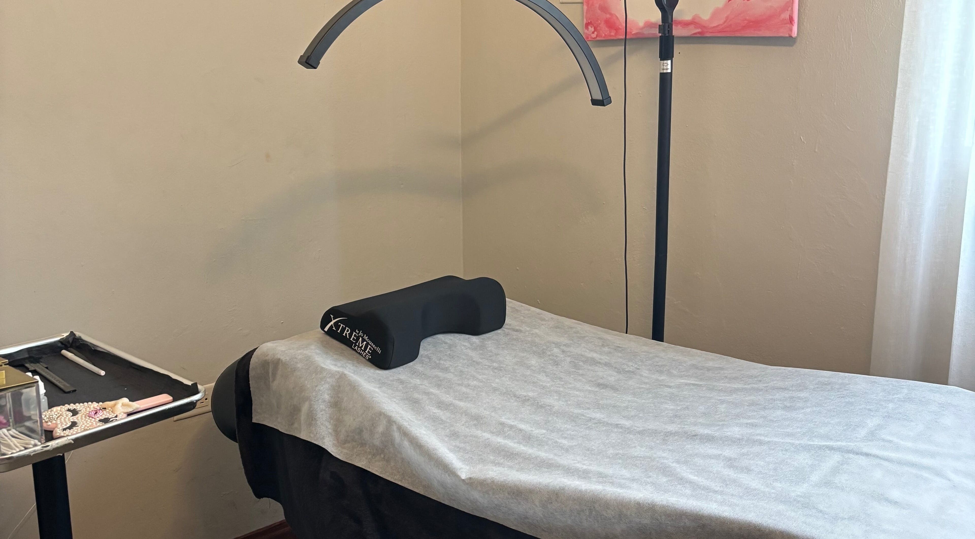 Eyelash extension setup at AP Beauty, Kingston, St. Andrew Parish, JM, showcasing a comfortable treatment bed.